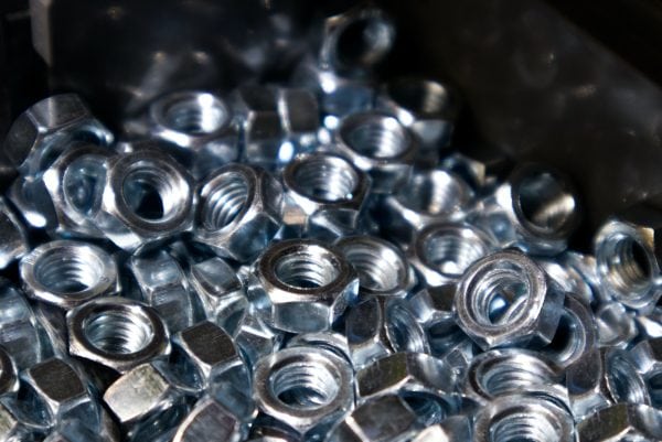 Lots of metal hex nuts close up